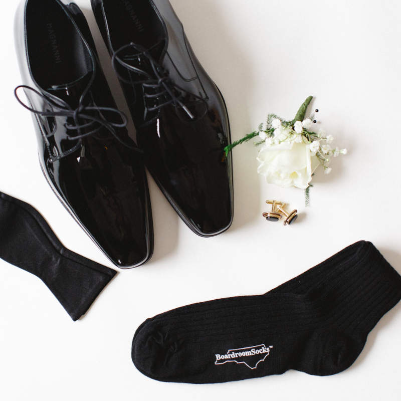 black socks for groomsmen with black patent leather shoes black bowtie and white boutonniere