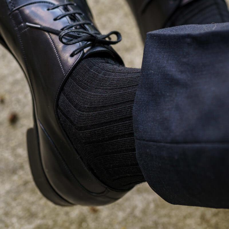 men's black dress socks paired with dark pants and black dress shoes
