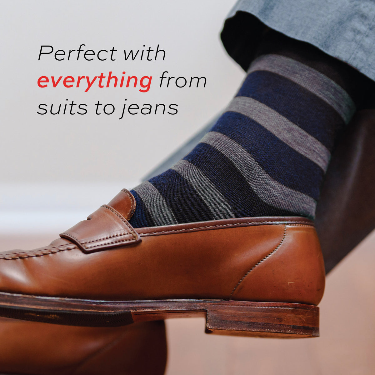 man wearing brown loafers and Grey Heather Stripes on Navy Merino Wool Mid-Calf Dress Socks with text overlay