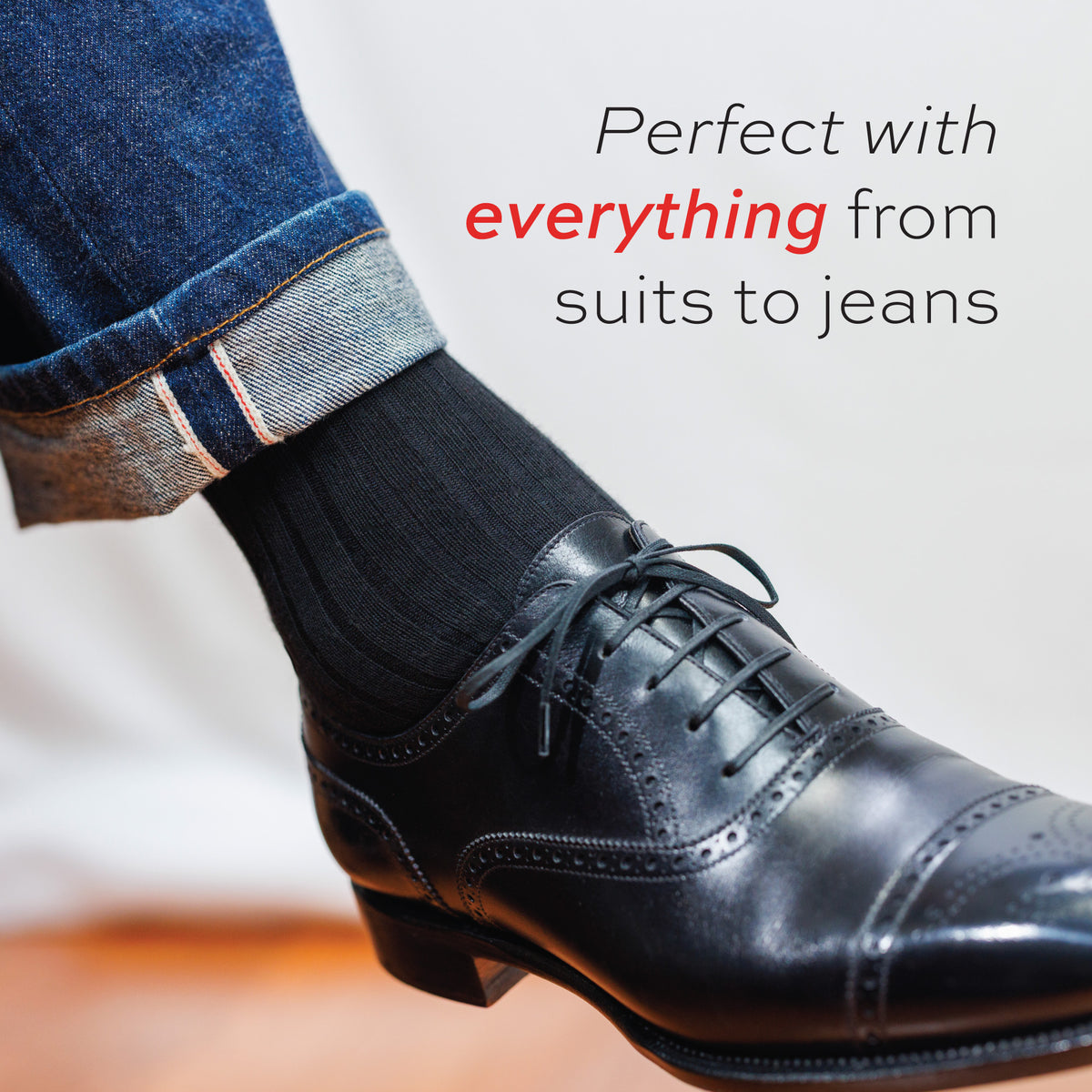 close up image of a mans leg wearing jeans, nice, shoes and Black Cotton Mid Calf Dress Socks