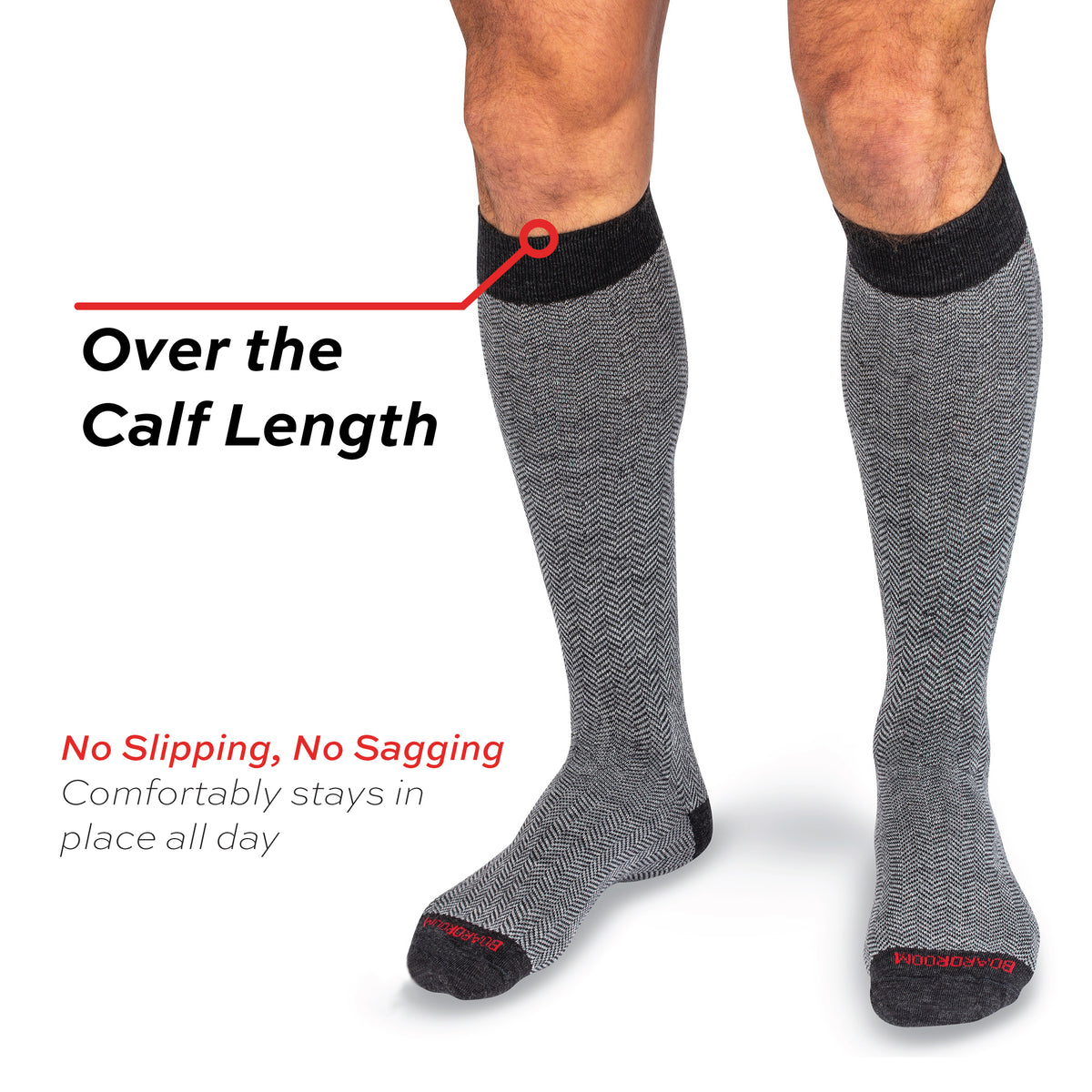 model wearing over the calf length merino wool grey herringbone men's dress socks on a white background