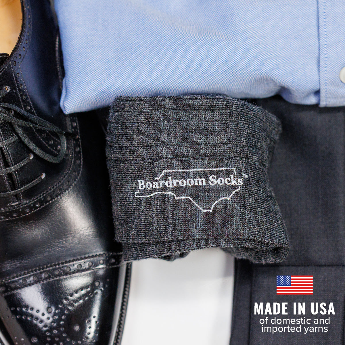 pair of grey heather merino wool dress socks atop business casual attire
