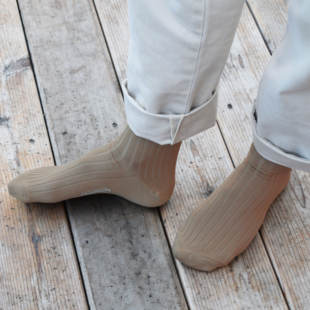 man standing on a deck wearing Khaki Cotton Over the Calf Dress Socks and khaki pants
