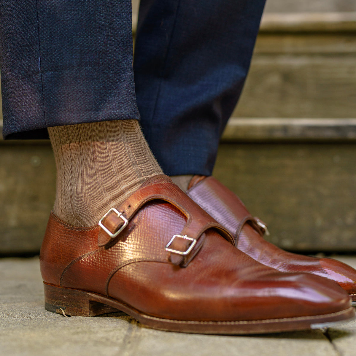 man standing outside wearing nice shoes, navy pants and Khaki Cotton Over the Calf Dress Socks