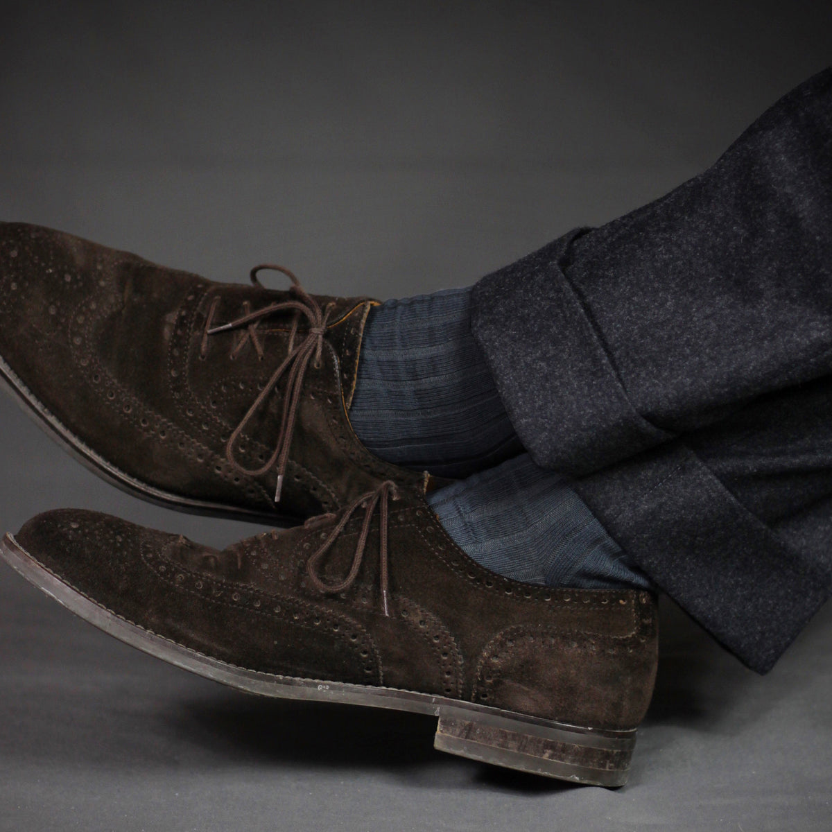 man sitting down crossing he legs and the ankles wearing Grey Cotton Over the Calf Dress Socks