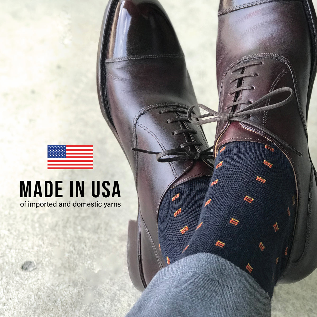man crossing his legs and the ankles wearing nice shoes and Orange Square Knots on Navy Merino Wool Over the Calf Dress Socks