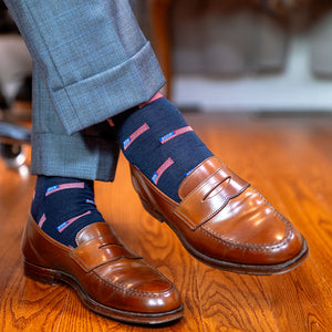 American flag dress socks paired with light grey slacks and brown penny loafers