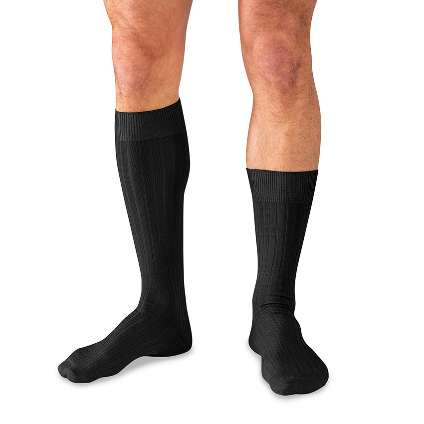 model wearing one over the calf dress sock and one mid-calf dress sock