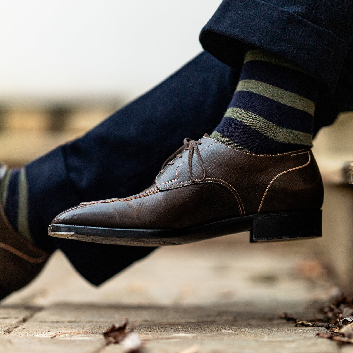 man wearing olive and navy striped merino wool dress socks with navy slacks and brown dress shoes