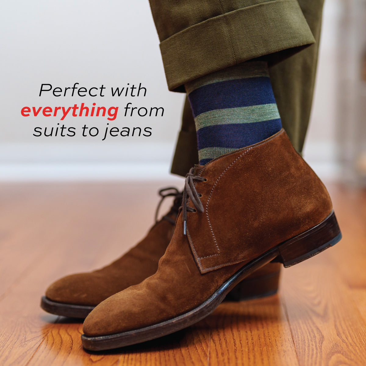 man standing on a hardwood floor wearing Olive Stripes on Navy Merino Wool Over the Calf Dress Socks with text overlay