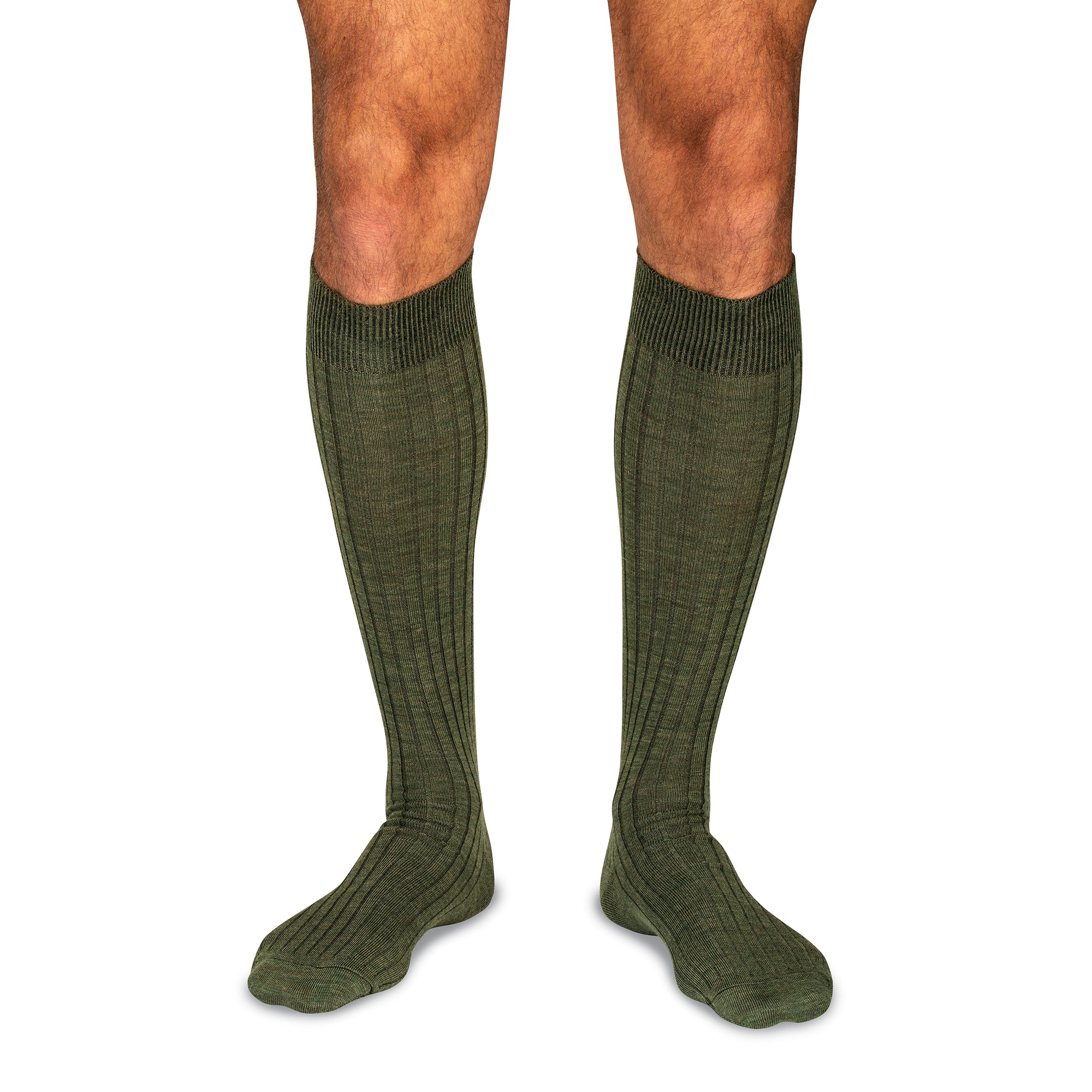 model wearing olive green merino wool over the calf dress socks