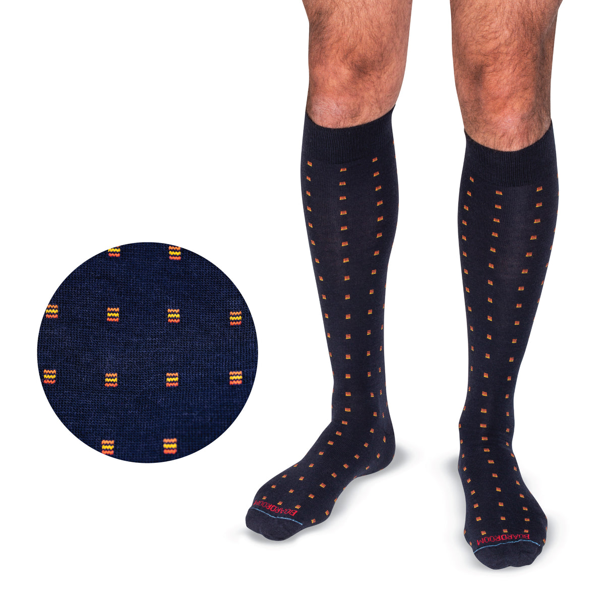 model wearing Orange Square Knots on Navy Merino Wool Over the Calf Dress Socks on a white background