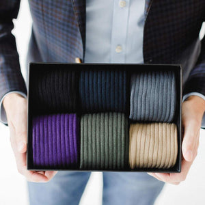 Man Holding Small Black Gift Box Filled with Colorful Men's Dress Socks