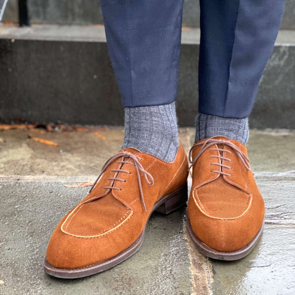 Man Wearing Navy Blue Dress Pants with Grey Merino Wool Dress Socks and Light Brown Suede Shoes