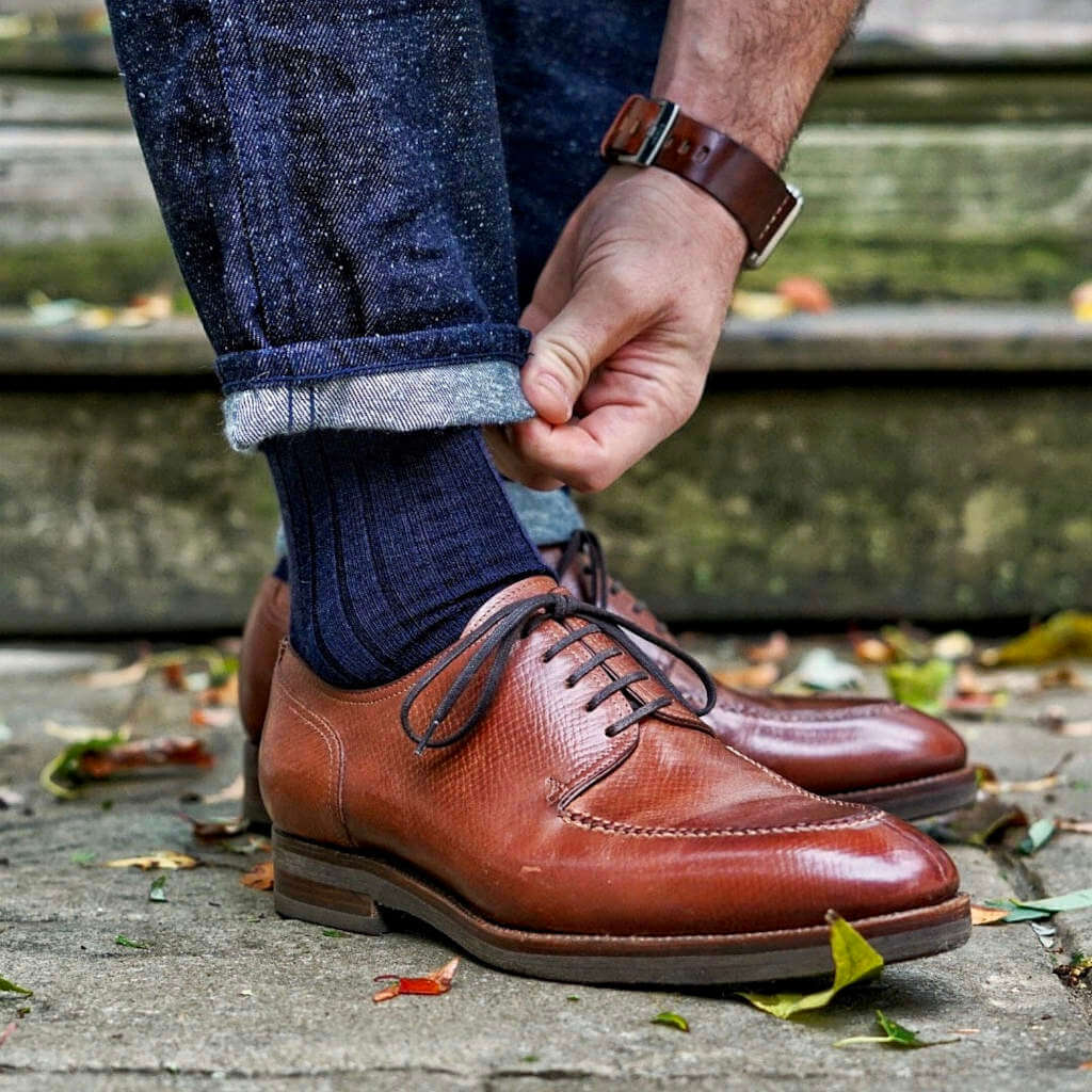 Man Wearing Navy Blue Merino Wool Dress Socks with Denim and Brown Dress Shoes