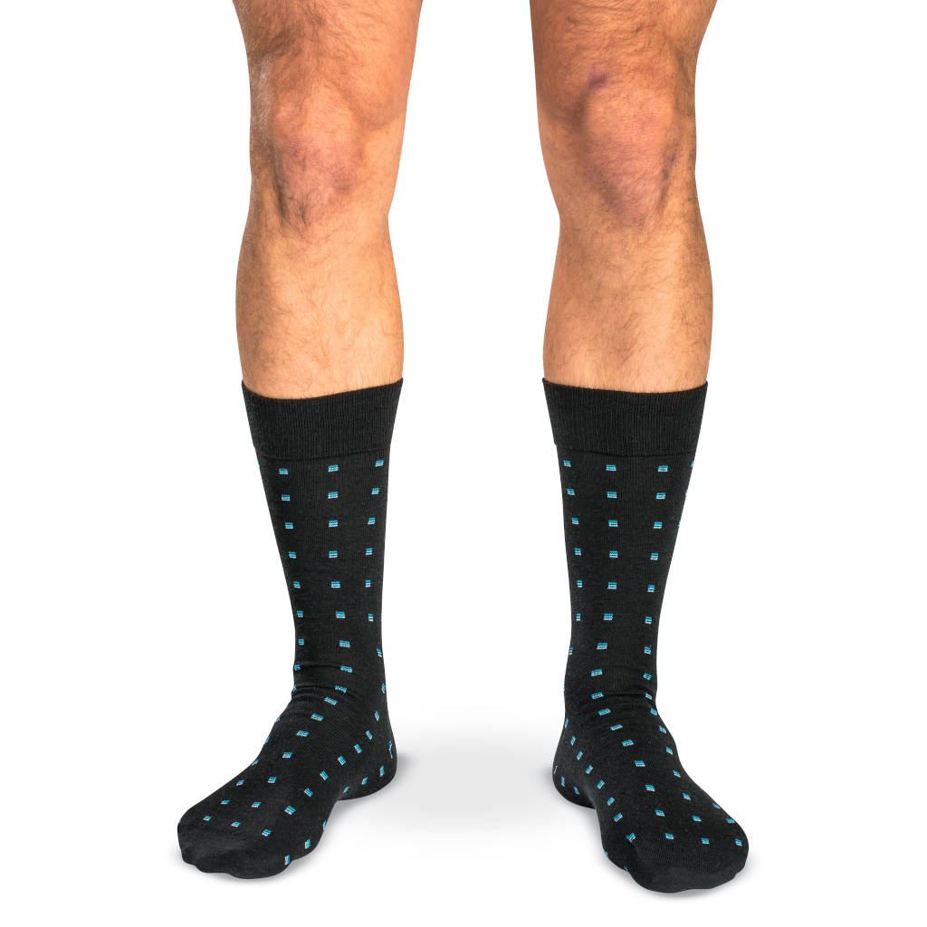 model wearing mid-calf length black patterned dress socks