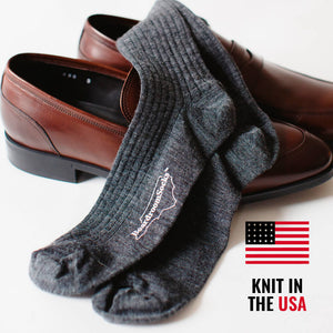 grey merino wool dress socks inside a pair of dark brown leather penny loafers