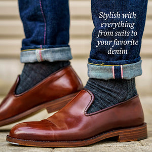 man wearing grey wool dress socks with dark wash denim and brown wholecut leather loafers
