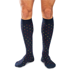 model wearing navy wool over the calf dress socks decorated with colorful polka dots