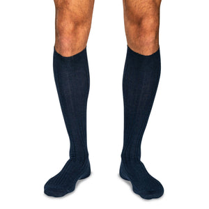 model wearing navy merino wool over the calf dress socks