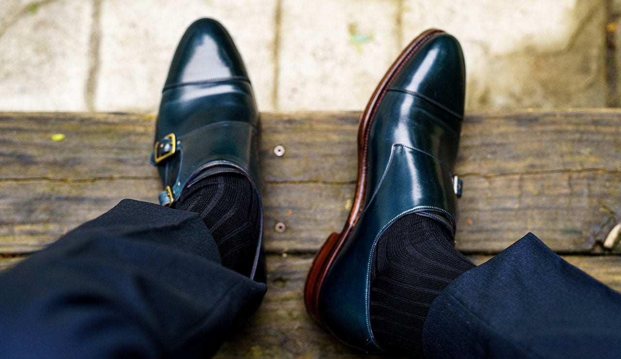 blue dress shoes with black dress socks and a navy suit