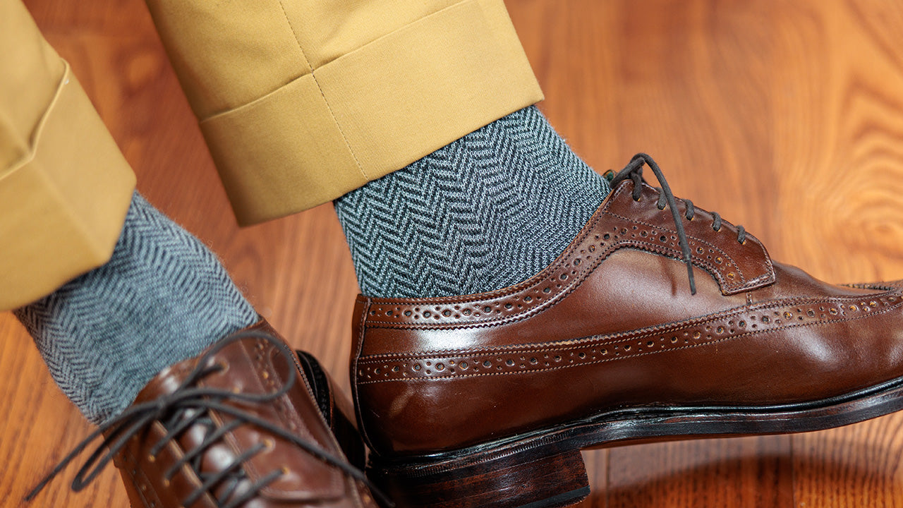 man wearing grey herringbone wool dress socks with brown wingtips and tan slacks