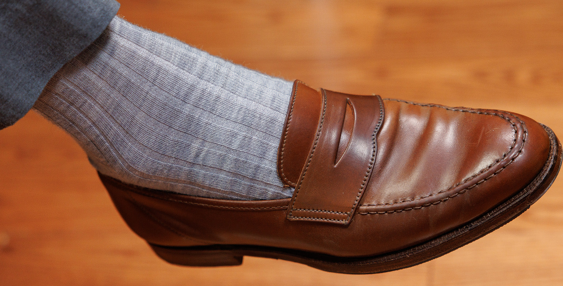 light grey heather wool dress socks paired with grey slacks and brown penny loafers