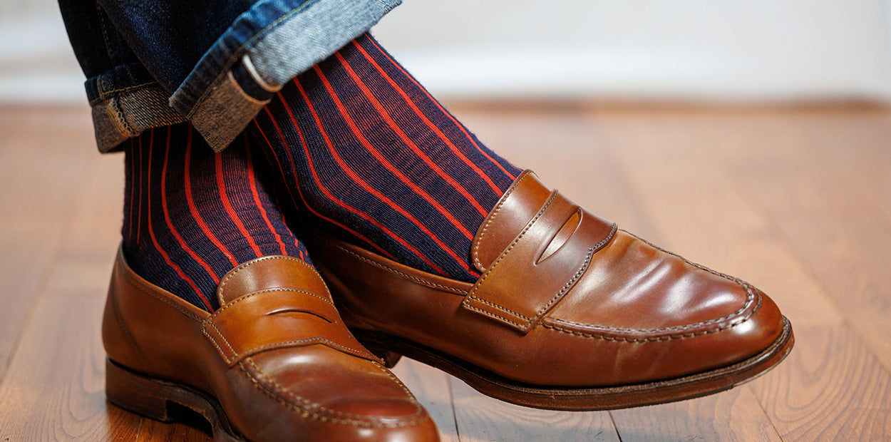 navy and red shadow stripe dress socks with penny loafers and jeans