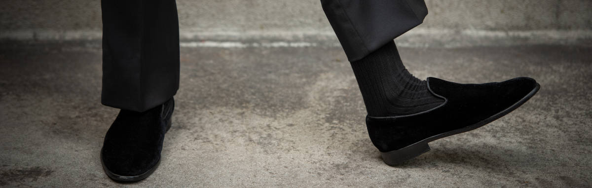 man wearing black tuxedo socks with black velvet slippers and tuxedo