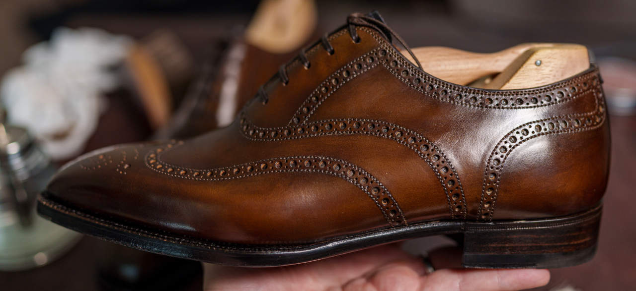 close up photo of wing tip style of dress shoes