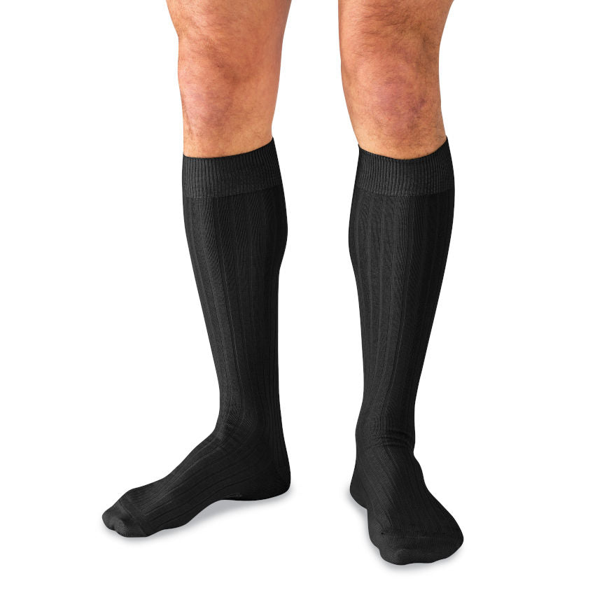 man wearing black over the calf dress socks