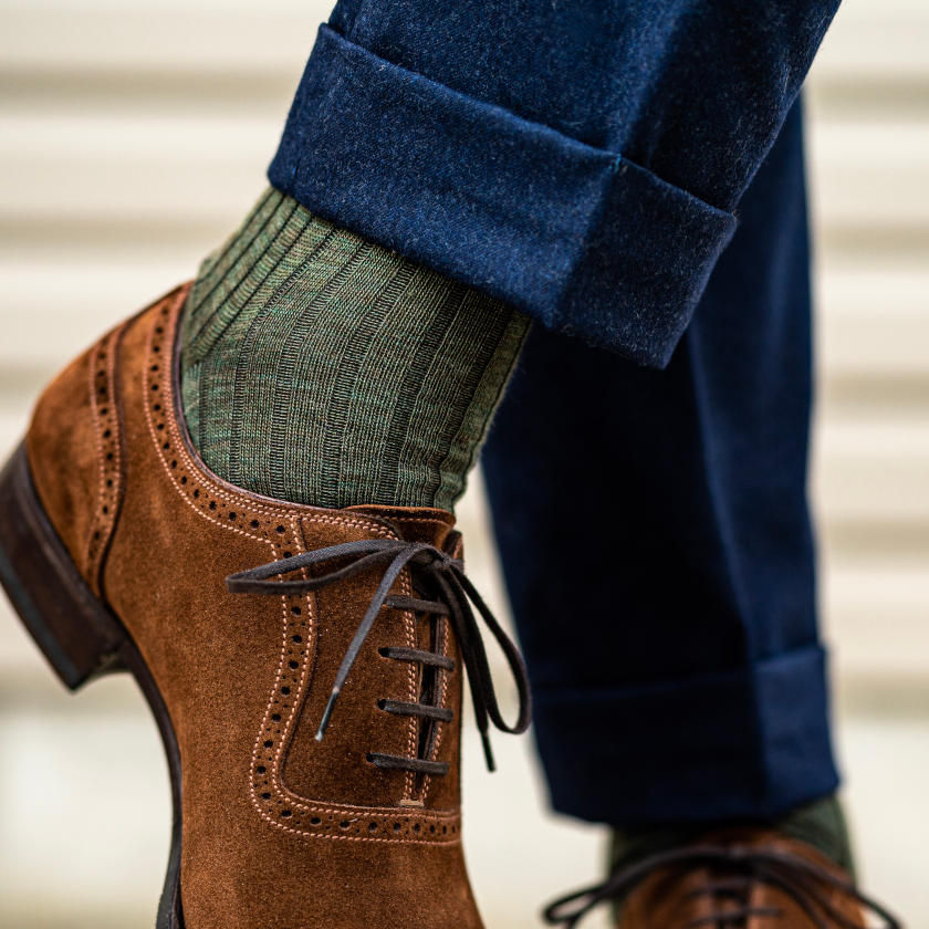 man wearing olive green dress socks with navy pants and brown suede dress shoes
