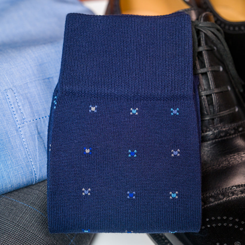 navy cotton geometric dress socks folded atop business attire