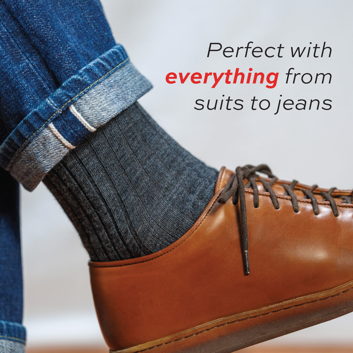 close up of a man wearing jeans and grey heather merino wool dress socks with prefect with everything text overlay