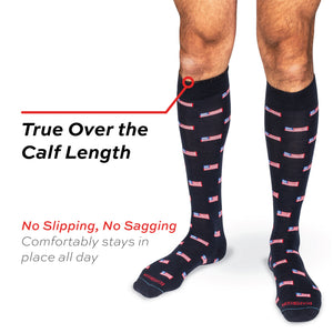model wearing true over the calf length merino wool dress socks with an american flag pattern