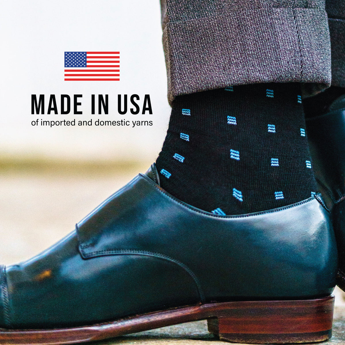 person's right foot wearing merino wool dress socks with made in USA text overlay