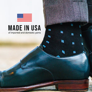 person's right foot wearing merino wool dress socks with made in USA text overlay