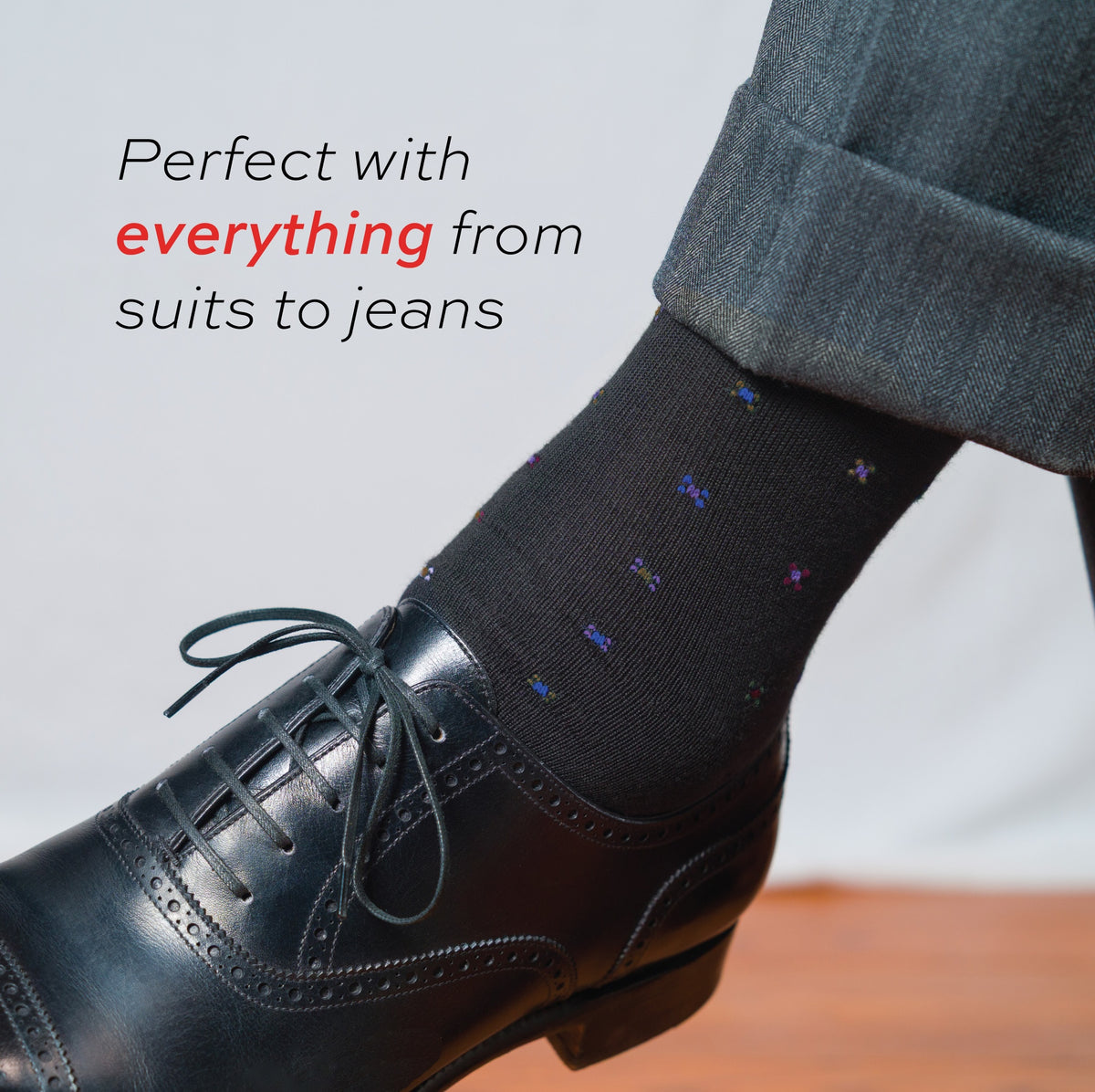 close up image of man wearing Black Geometric Merino Wool Over the Calf Dress Socks with text overlay
