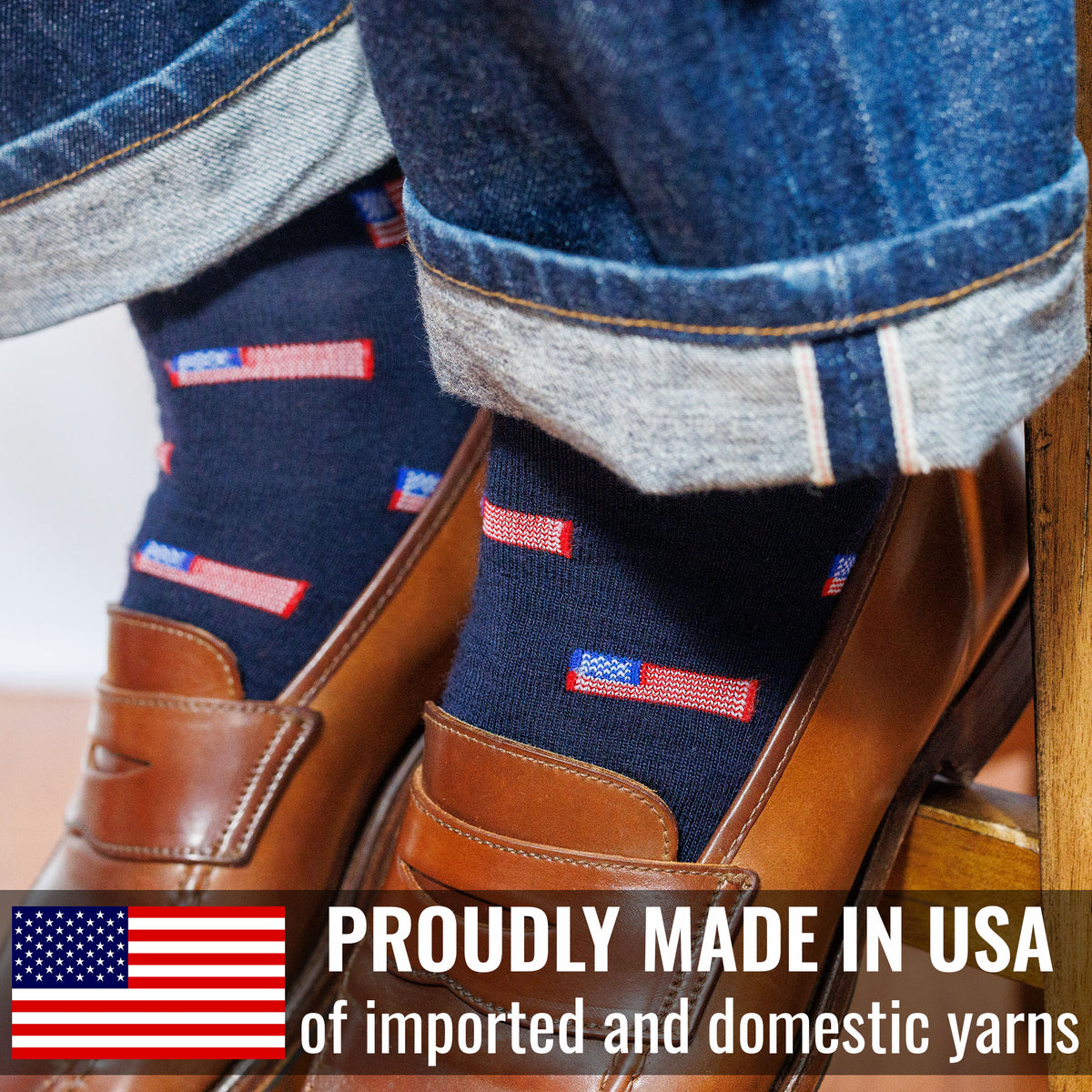 Navy dress socks with American flag design worn with brown shoes, text &#39;Proudly Made in USA of imported and domestic yarns&#39; displayed.