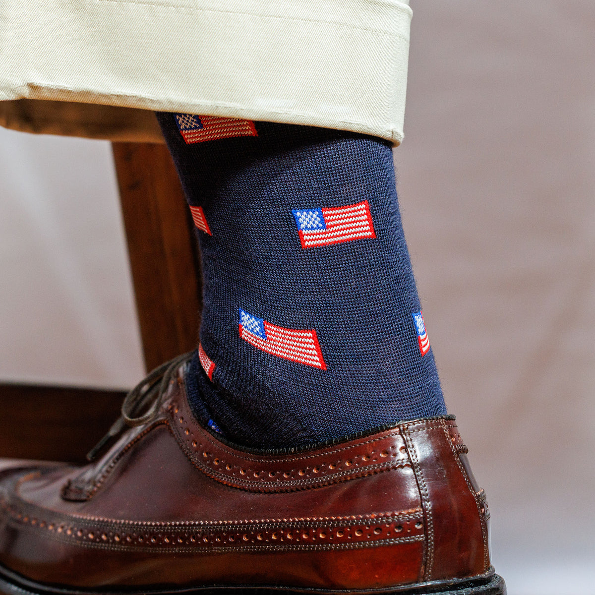 navy merino wool dress socks with American flags, khaki pants and brown wingtips