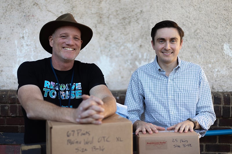 Nathan and Randall with donated socks from Boardroom Socks to Roof Above