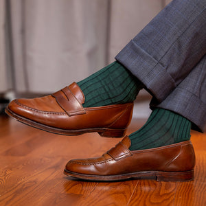 racing green dress socks paired with a grey windowpane suit and brown penny loafers