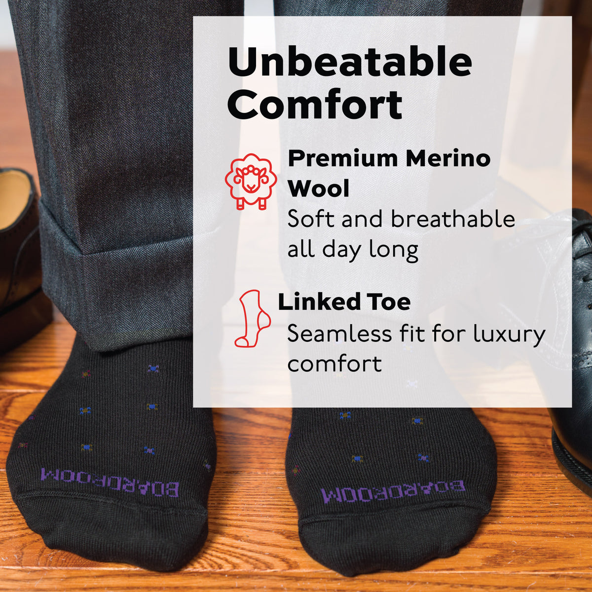 man standing on wood floors wearing Black Geometric Merino Wool Over the Calf Dress Socks