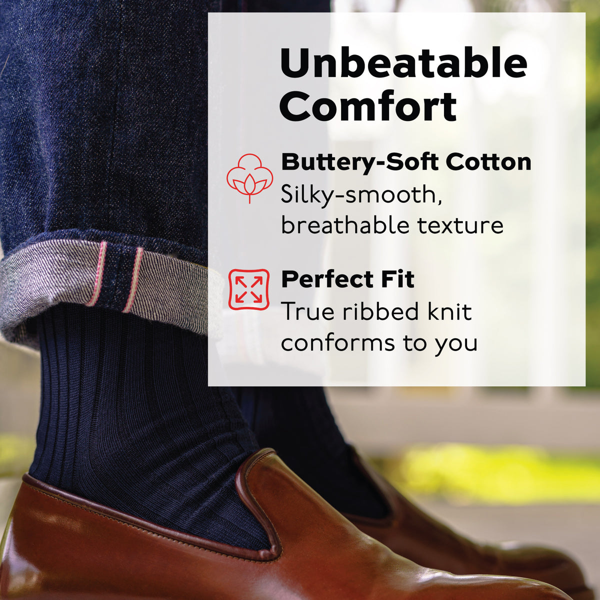 image of a man standing outside wearing navy cotton mean dress socks and jeans with brown loafers
