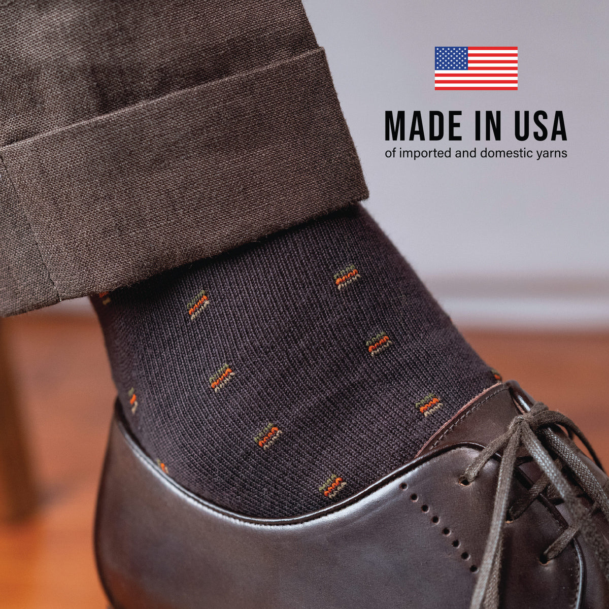 made in usa text overlay on close up image of a foot wearing slacks, nice shoes and brown cotton socks with a square knot patttern