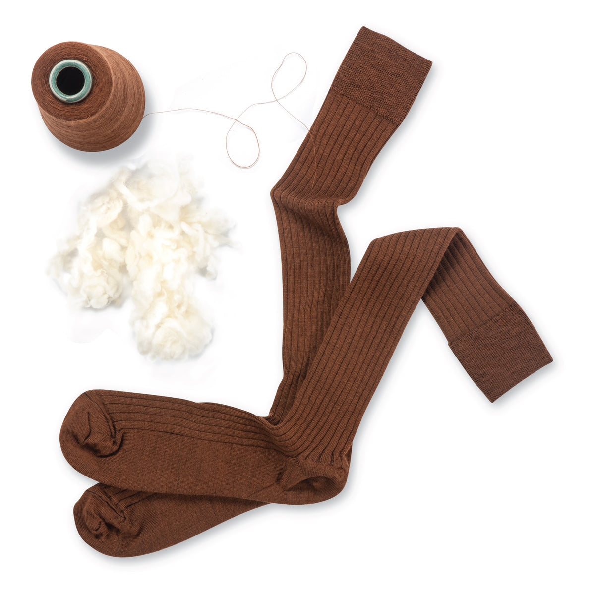 Over the Calf brown merino wool mens dress socks laying flat on a white surface with yarn and wool beside them