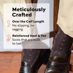 close up image of the legs of a man sitting on a stool wearing brown patterned dress socks worn with chinos and loafers and text overlay about craftsmanship