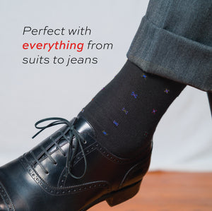 close up image of man wearing black shoes and Black Geometric Merino Wool Mid-Calf Dress Socks