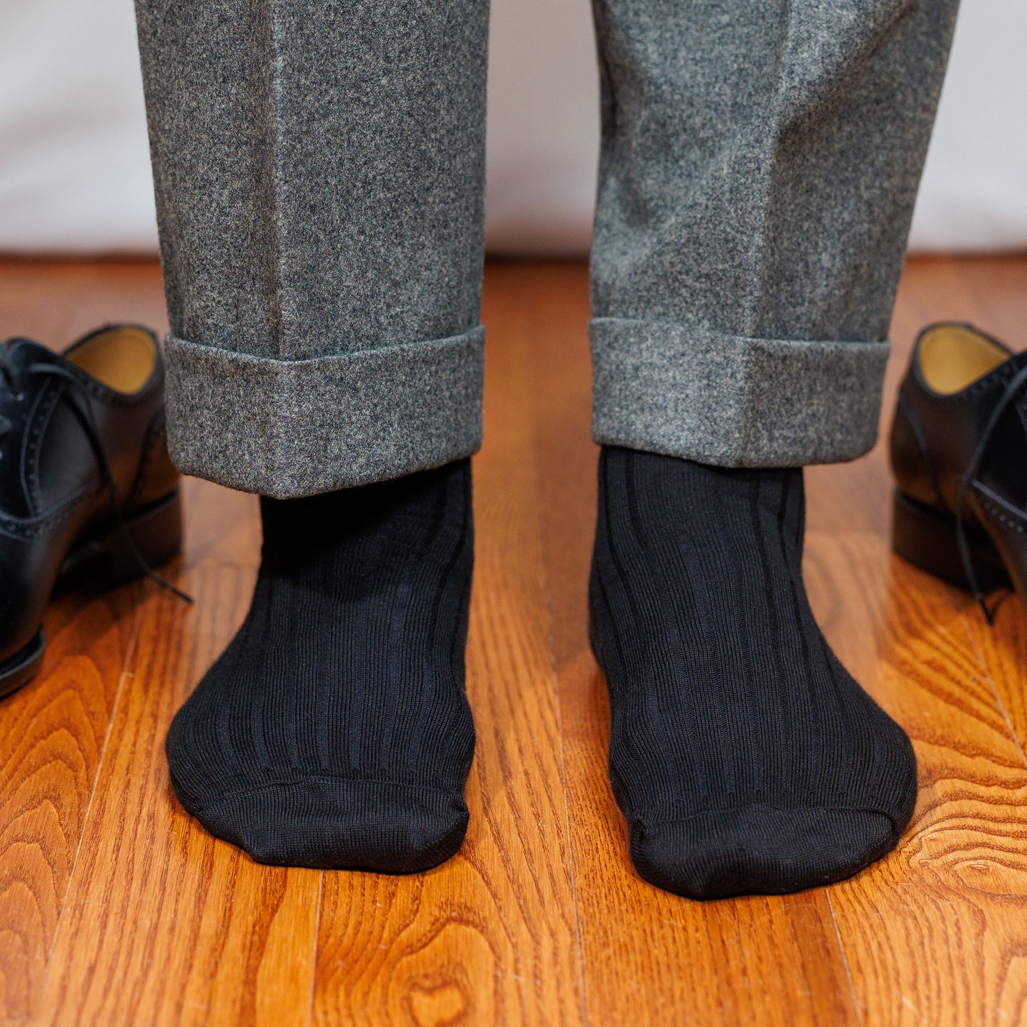 black cotton dress socks paired with grey trousers and black oxfords