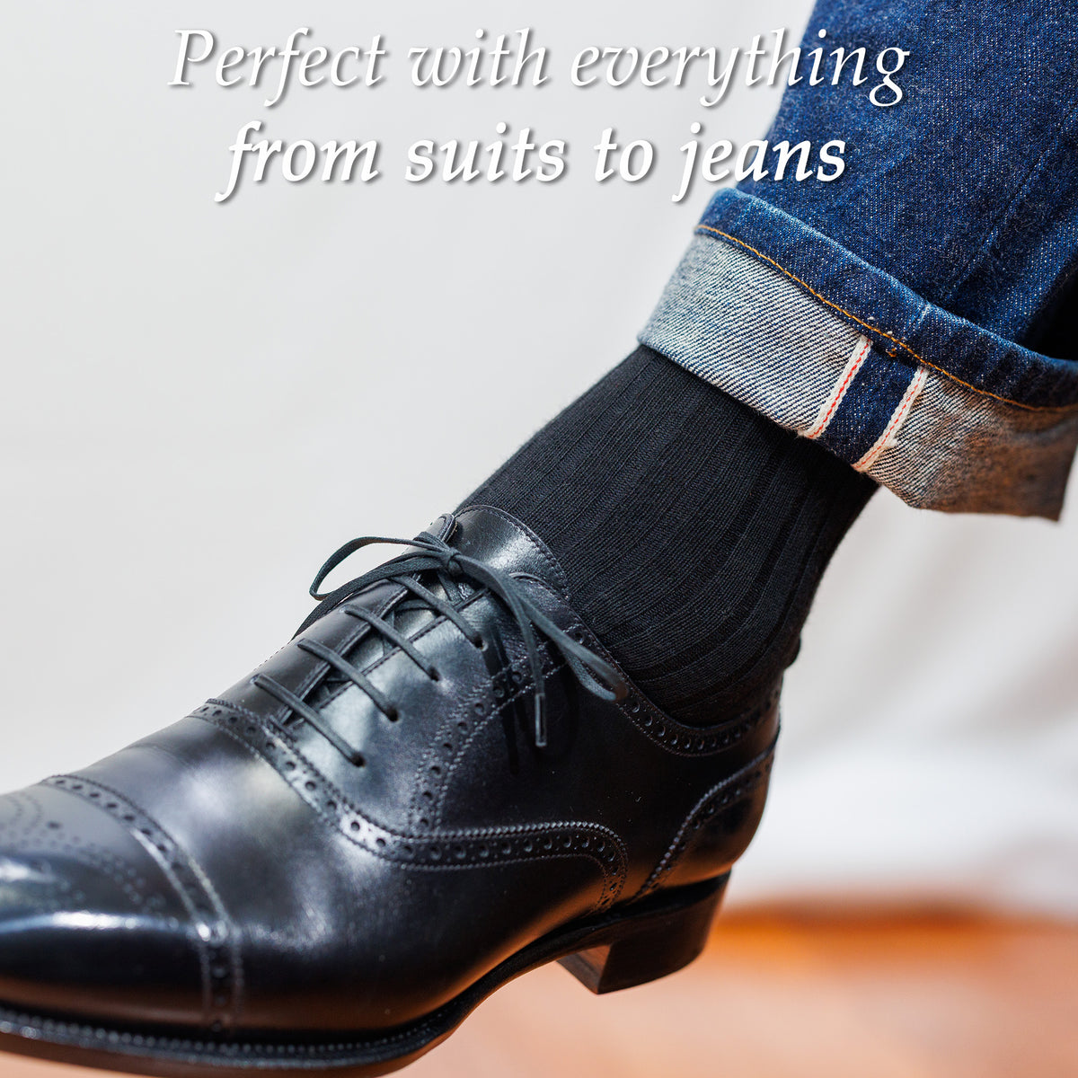man wearing black cotton dress socks with jeans and black oxfords